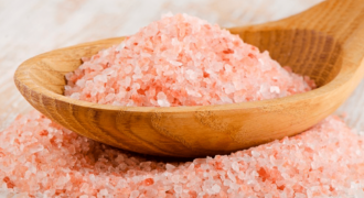 Por qué la sal rosada del Himalaya es tan popular 2 Cristales de sal rosada del Himalaya en un recipiente de cocina
