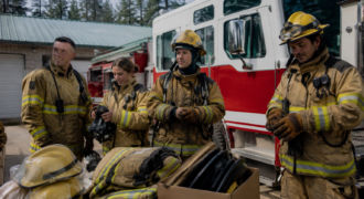 Firefighters Preparing Gear by Engine